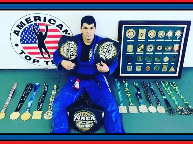 Coach Marcel Ferreira with his NAGA championship belts and medals at American Top Team Winter Garden